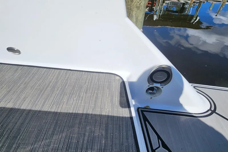 Slide: The Image of 2023 Four Winns HD8 OB boat deck with speaker and water reflection. - 76