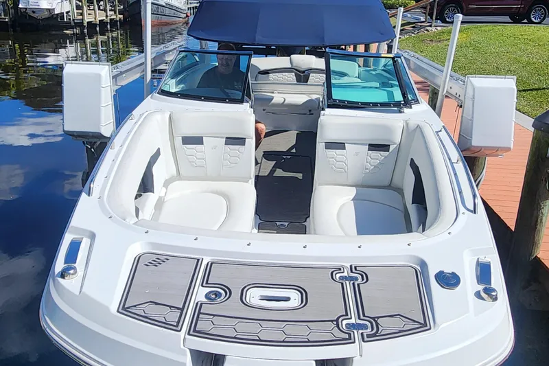 Slide: The Image of 2023 Four Winns HD8 OB boat with sleek design, docked by the water. - 78
