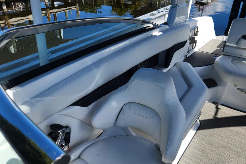 Slide: The Image of 2023 Four Winns HD8 OB boat interior with white seating and sleek design. - 9