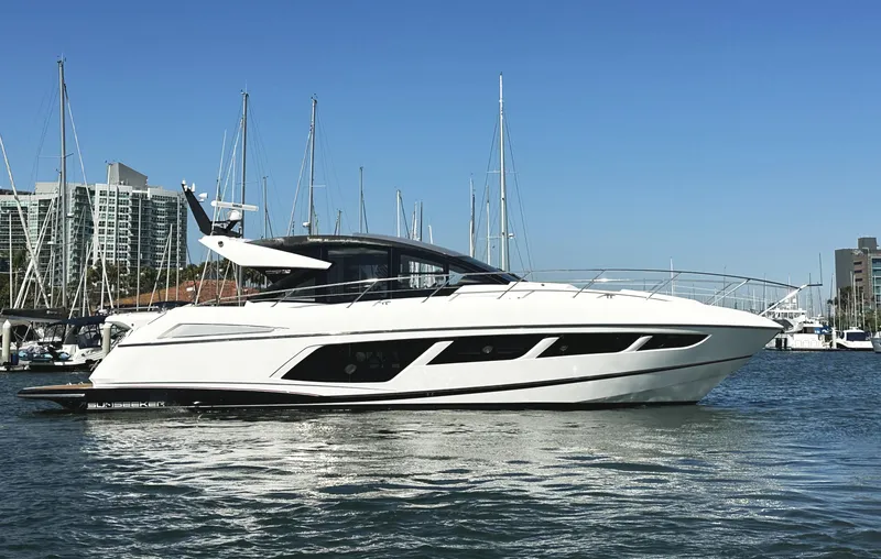The Image of 2019 Sunseeker Predator 57 yacht docked in marina, clear blue sky background. - 0