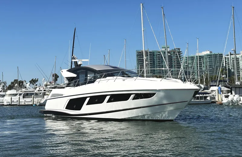 Slide: The Image of 2019 Sunseeker Predator 57 yacht docked in marina, clear blue sky background. - 2