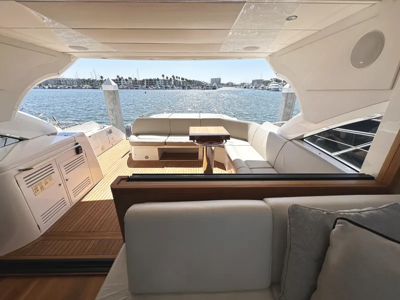 Slide: The Image of Luxurious 2019 Sunseeker Predator 57 yacht interior with elegant seating and scenic ocean view. - 22