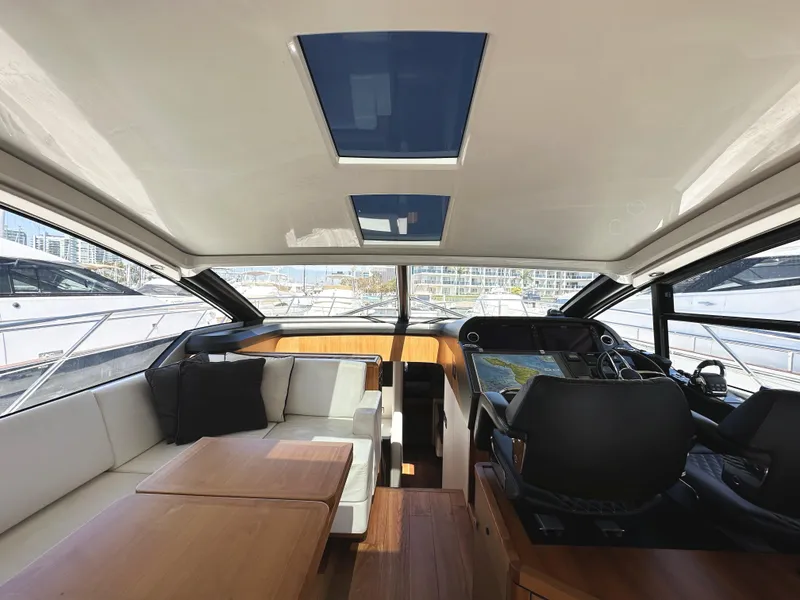 Slide: The Image of Interior of 2019 Sunseeker Predator 57 yacht, featuring luxurious seating and modern navigation controls. - 24