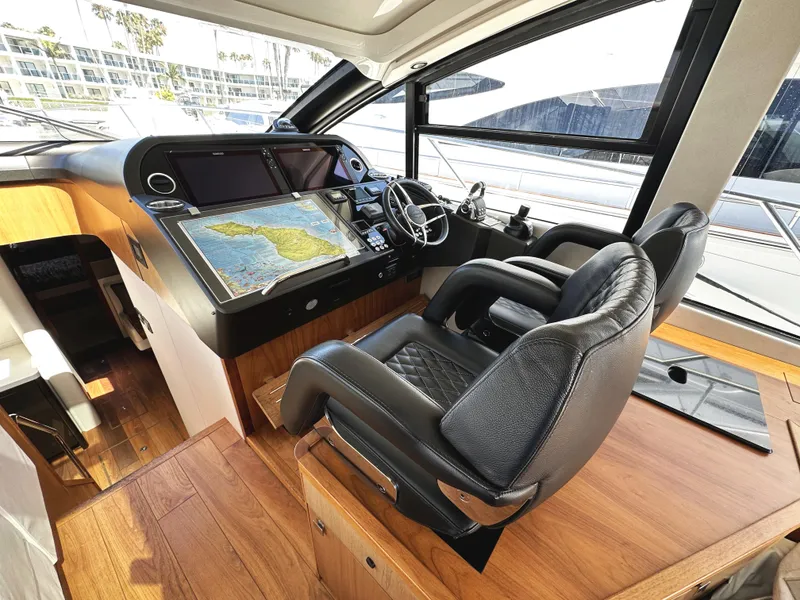 Slide: The Image of Luxurious 2019 Sunseeker Predator 57 yacht cockpit with leather seats and navigation screens. - 26