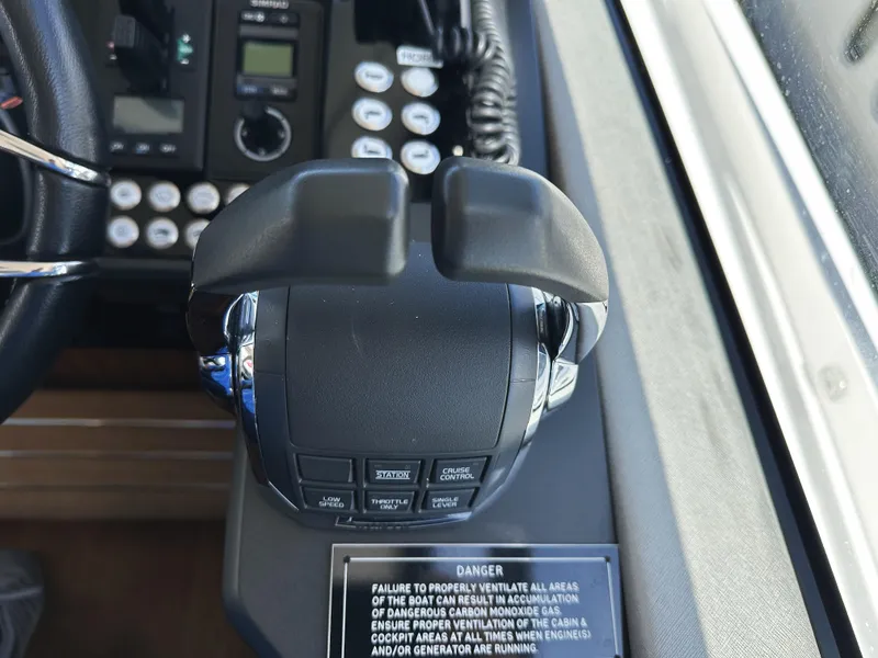 Slide: The Image of Control panel of a 2019 Sunseeker Predator 57 yacht, featuring throttle and warning label. - 32
