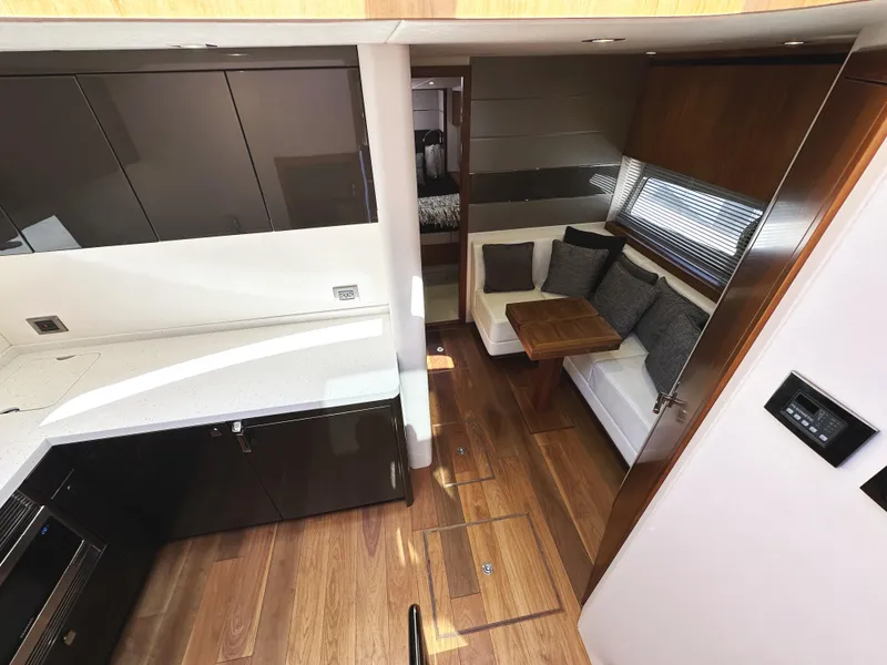 Slide: The Image of Luxurious interior of 2019 Sunseeker Predator 57 yacht with modern kitchen and cozy seating area. - 34