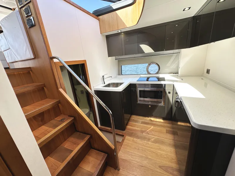 Slide: The Image of Luxurious kitchen interior of 2019 Sunseeker Predator 57 yacht with modern appliances and wood accents. - 35