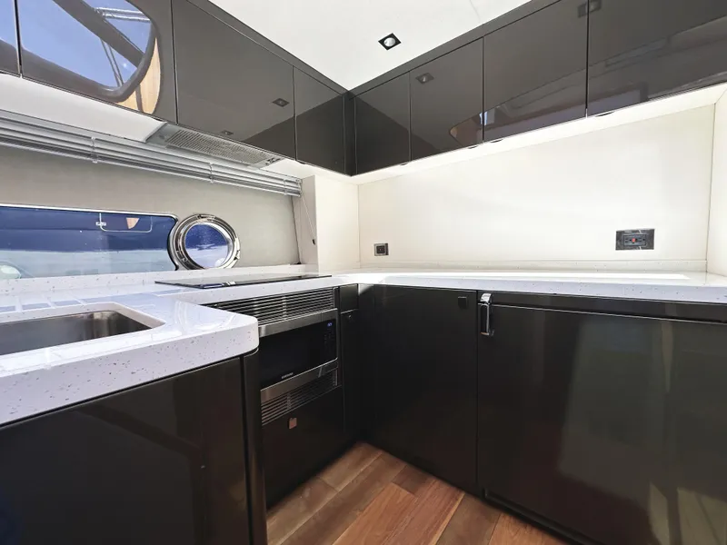 Slide: The Image of Modern kitchen interior on 2019 Sunseeker Predator 57 yacht, featuring sleek cabinetry and appliances. - 38