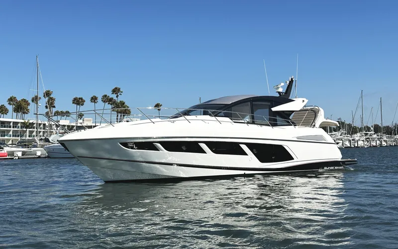Slide: The Image of 2019 Sunseeker Predator 57 yacht on water, clear sky, marina background. - 4