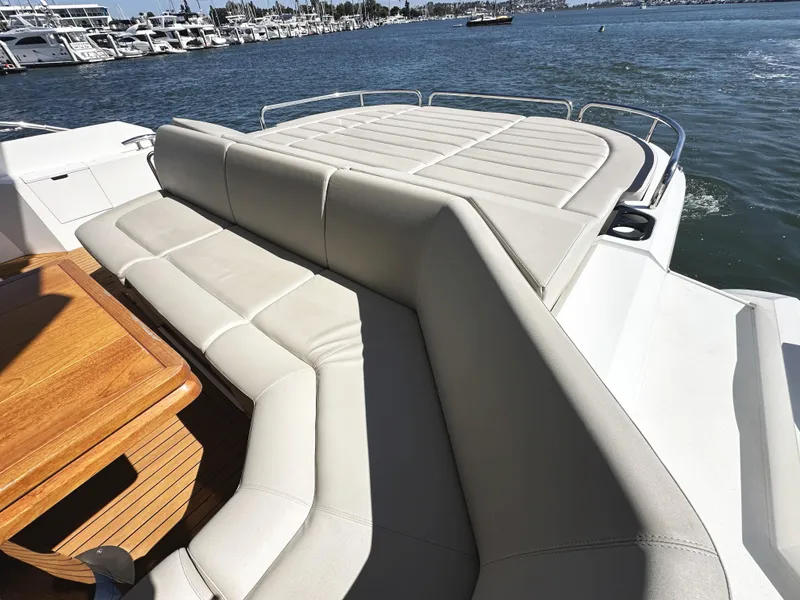 Slide: The Image of Luxurious seating area on 2019 Sunseeker Predator 57 yacht, overlooking marina. - 8