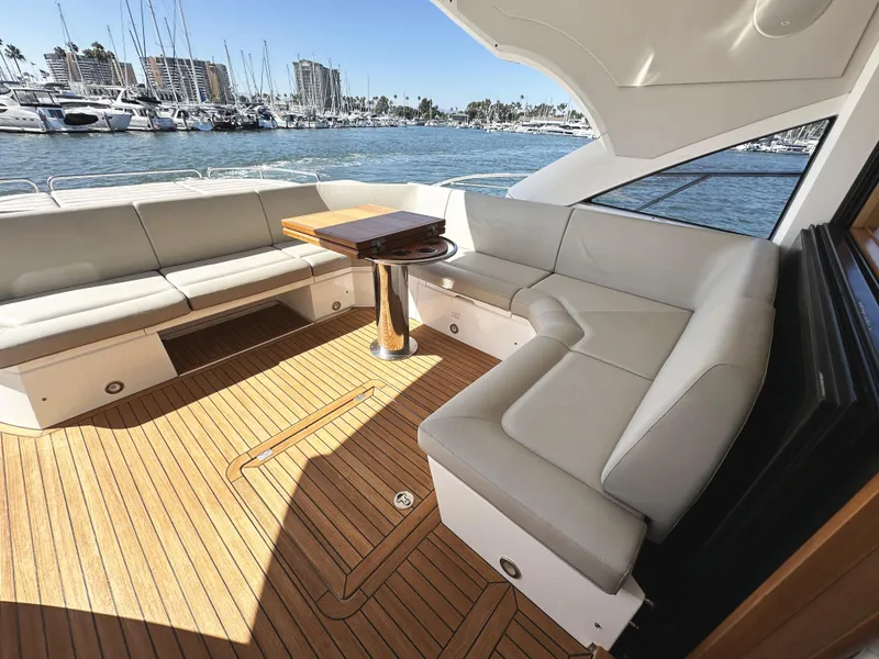 Slide: The Image of Luxurious 2019 Sunseeker Predator 57 yacht interior with elegant seating and wooden deck. - 9