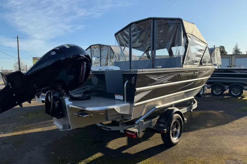 Slide: The Image of 2026 Thunder Jet 185 Luxor boat with Mercury outboard motor, parked on a trailer. - 34