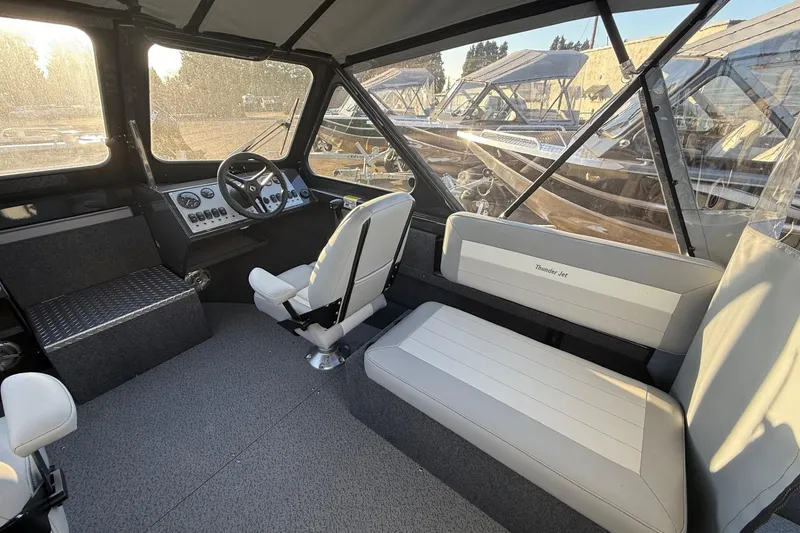 Slide: The Image of 2026 Thunder Jet 185 Luxor boat interior with steering wheel and seating. - 44
