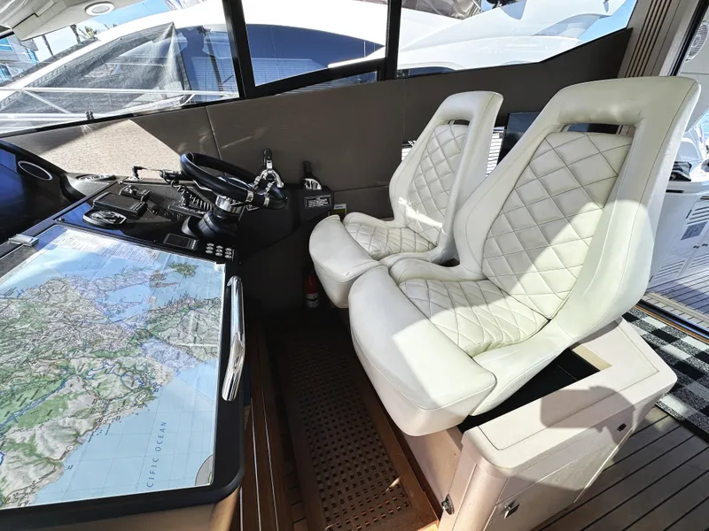 Slide: The Image of Luxurious cockpit of 2015 Sunseeker Predator 57 yacht with white leather seats and navigation map. - 18