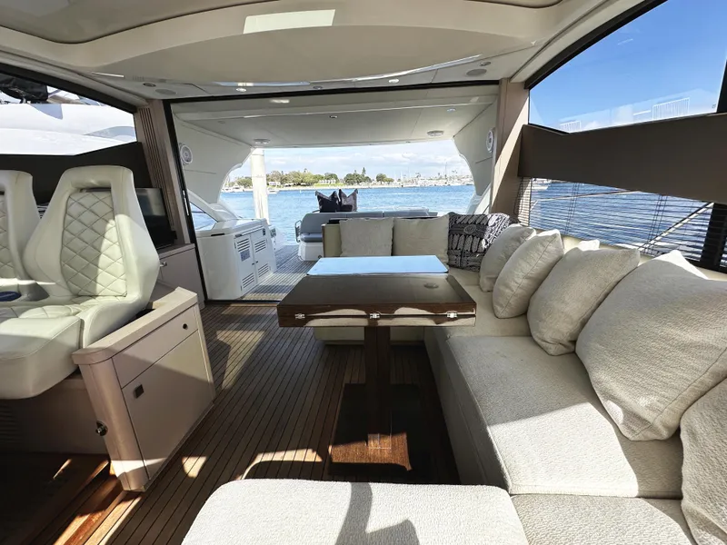 Slide: The Image of Luxurious interior of a 2015 Sunseeker Predator 57 yacht with elegant seating and scenic water view. - 21