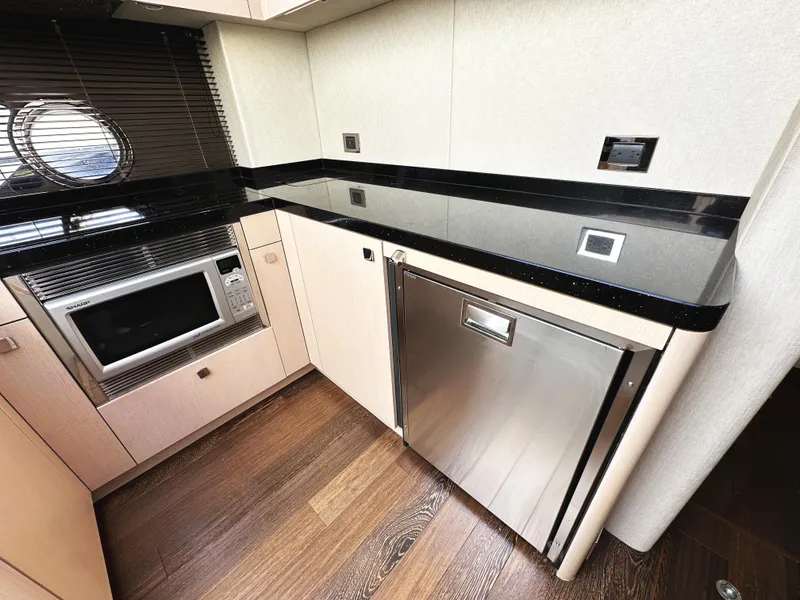Slide: The Image of Modern kitchen area in 2015 Sunseeker Predator 57 yacht with microwave and fridge. - 22