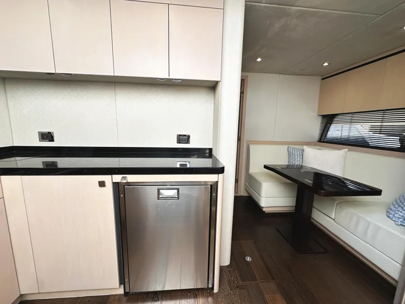 Slide: The Image of Interior of 2015 Sunseeker Predator 57 yacht with modern kitchen and dining area. - 24