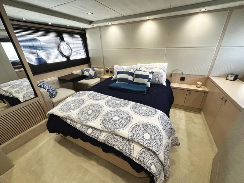 Slide: The Image of Luxurious bedroom interior of 2015 Sunseeker Predator 57 yacht, featuring elegant bedding and modern design. - 36
