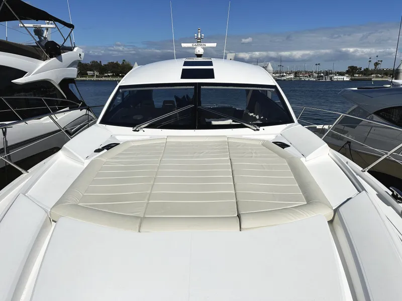 Slide: The Image of 2015 Sunseeker Predator 57 yacht with spacious sunbathing deck, docked at marina. - 43
