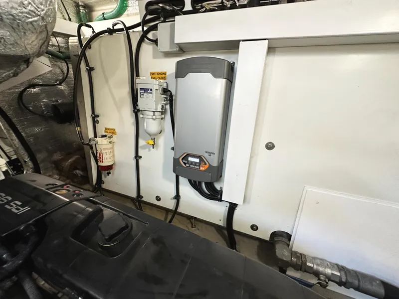 Slide: The Image of Engine room of 2015 Sunseeker Predator 57 yacht, showcasing mechanical components and wiring. - 47