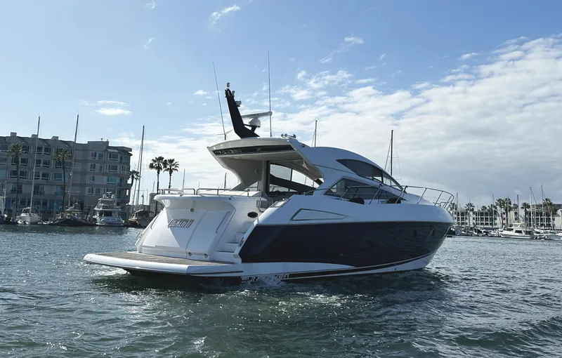 Slide: The Image of 2015 Sunseeker Predator 57 yacht cruising in a marina under a partly cloudy sky. - 6