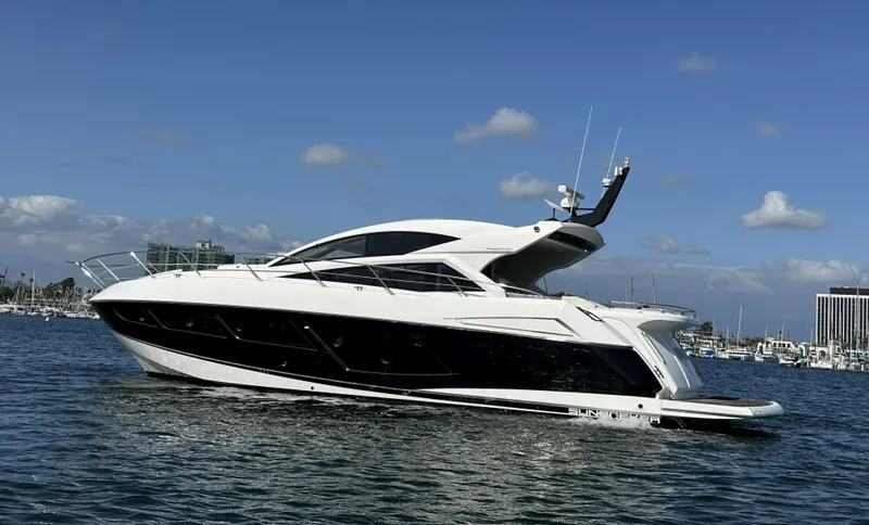 Slide: The Image of 2015 Sunseeker Predator 57 yacht on calm water under blue sky. - 8