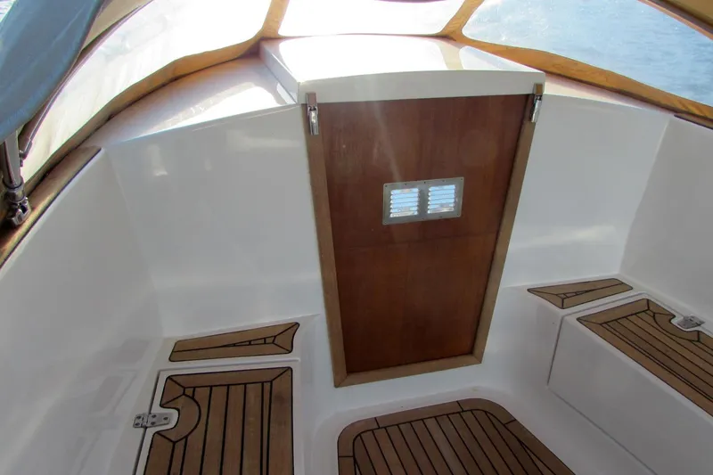 Slide: The Image of 2014 AdmiralsTender C28 boat interior with wooden accents and seating. - 12