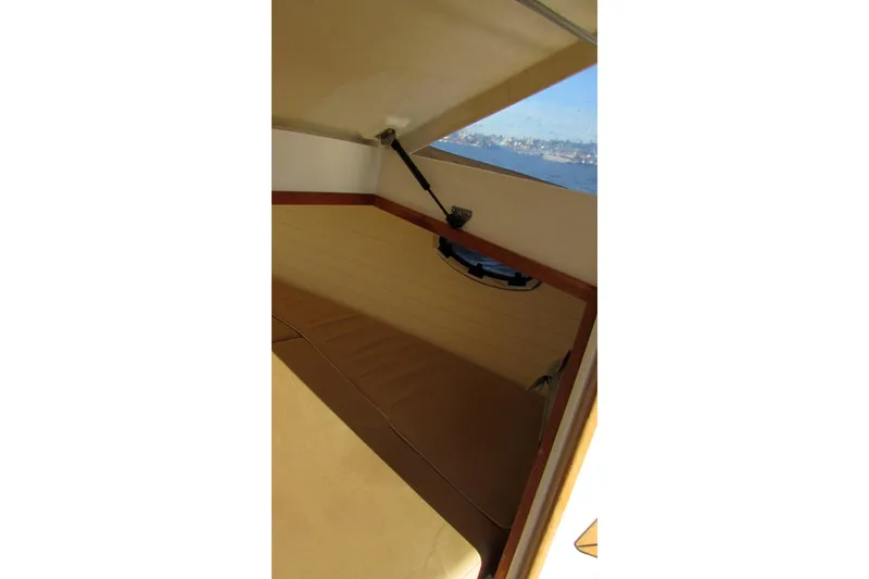 Slide: The Image of Interior view of 2014 AdmiralsTender C28 boat cabin with window and seating. - 13