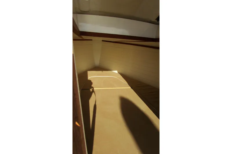 Slide: The Image of 2014 AdmiralsTender C28 cabin interior with beige cushions and wooden accents. - 14