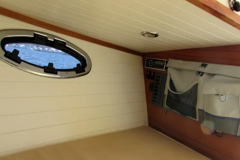 Slide: The Image of Interior of 2014 AdmiralsTender C28 boat with porthole and storage compartments. - 15