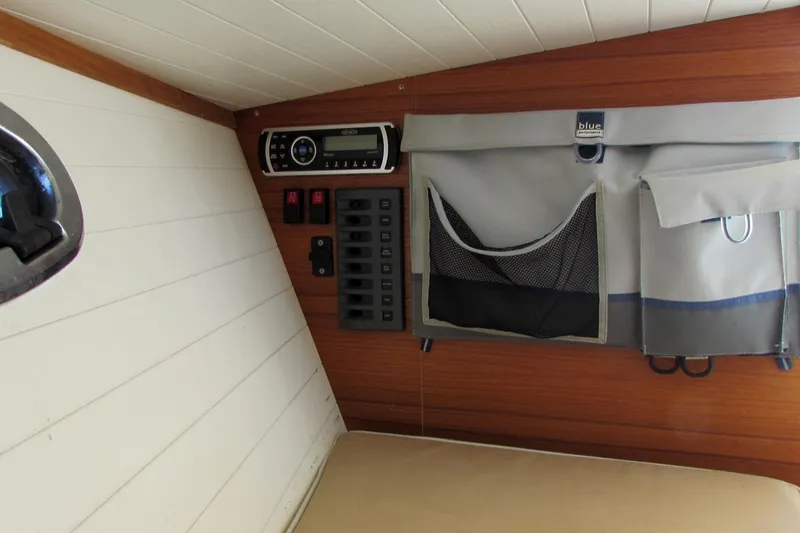 Slide: The Image of Interior of 2014 AdmiralsTender C28 with control panel and storage pockets. - 16