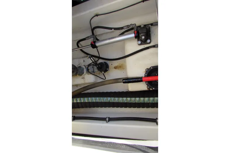 Slide: The Image of Engine compartment of 2014 AdmiralsTender C28 boat showing hoses and wiring. - 17