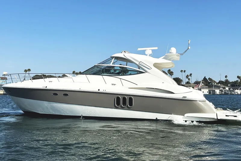 Slide: The Image of 2007 Cruisers Yachts 540 Express on water, sleek design, sunny day, palm trees in background. - 1