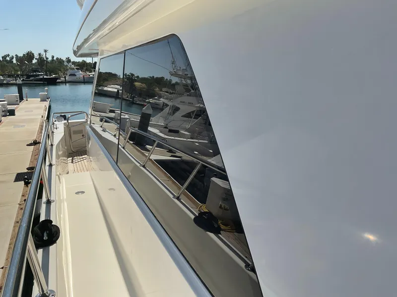 Slide: The Image of 2002 West Bay Sonship yacht docked at marina, side view with sleek design. - 40