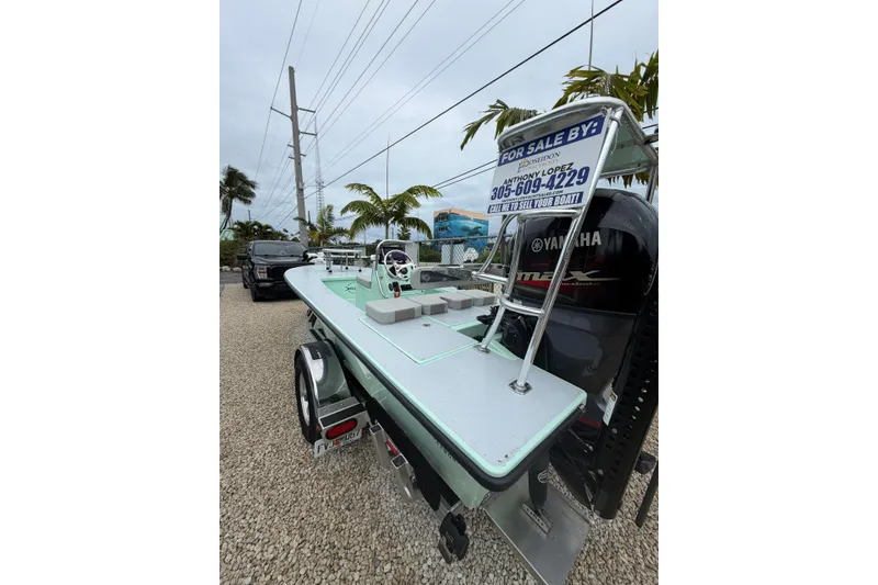 Slide: The Image of 2024 Hell's Bay Professional boat for sale, displayed on a trailer with Yamaha engine. - 2