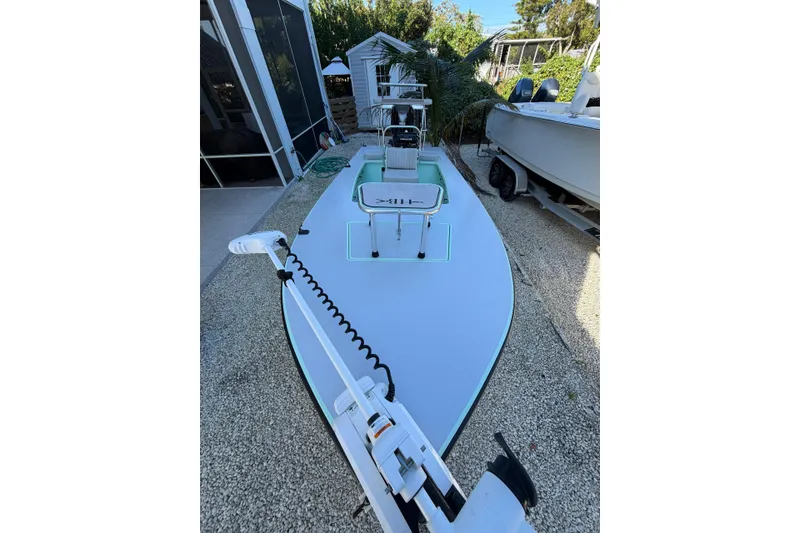 Slide: The Image of 2024 Hell's Bay Professional boat on trailer, parked outdoors. - 3