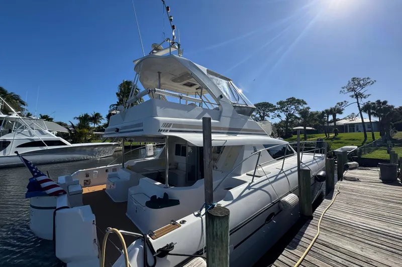 Slide: The Image of Luxury Africat Marine 420 yacht docked, 2007 model, under clear blue sky. - 100