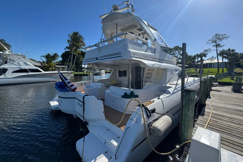 Slide: The Image of 2007 Africat Marine 420 yacht docked at marina under clear blue sky. - 102
