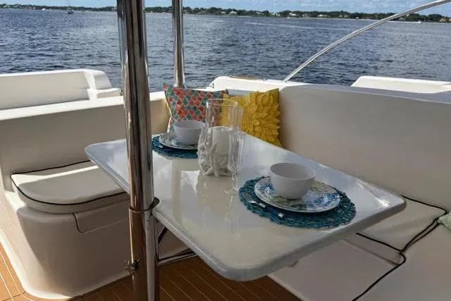 Slide: The Image of Luxury Africat Marine 420 yacht dining area with ocean view, featuring elegant table setting, 2007 model. - 11