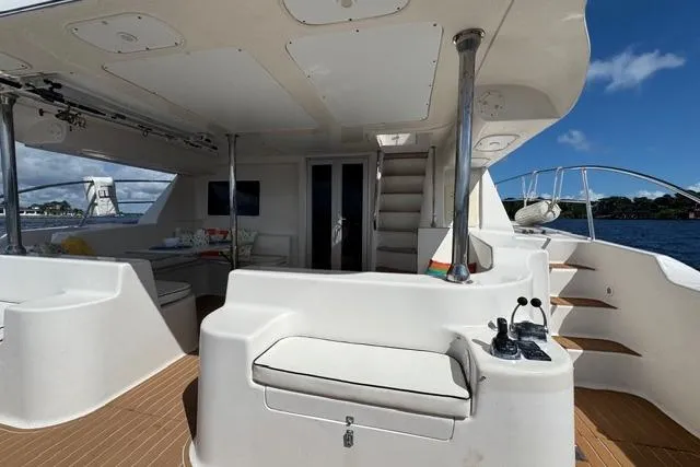 Slide: The Image of Luxurious 2007 Africat Marine 420 yacht interior with seating and stairs, docked by the water. - 12