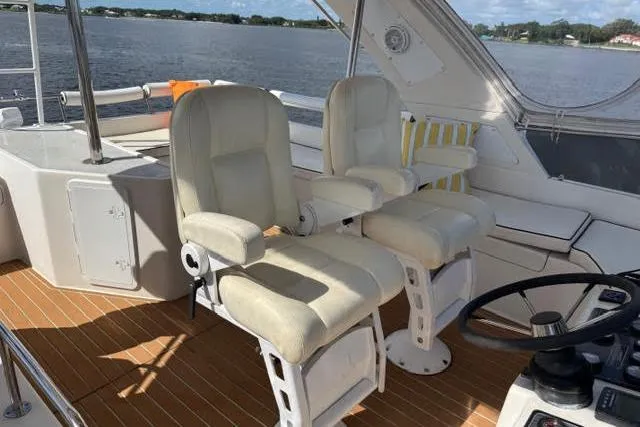Slide: The Image of Luxury Africat Marine 420 yacht interior with plush seating, 2007 model, overlooking serene waters. - 16