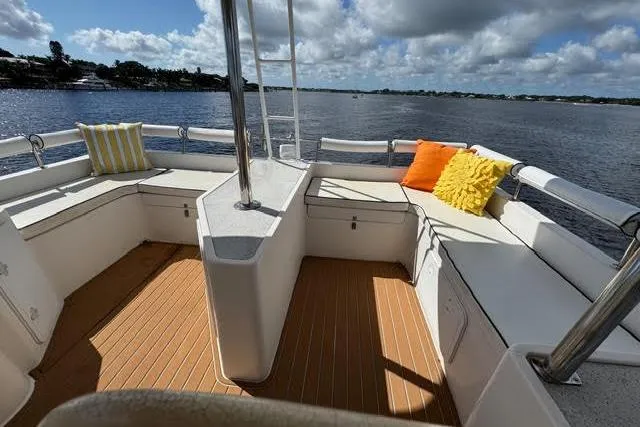 Slide: The Image of 2007 Africat Marine 420 boat deck with seating, colorful cushions, and scenic water view. - 17