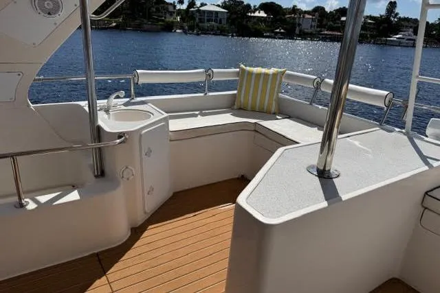 Slide: The Image of Luxurious Africat Marine 420 yacht deck with seating, 2007 model, overlooking serene waterfront. - 18