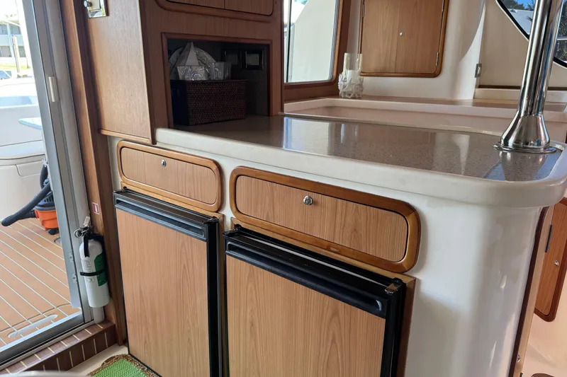 Slide: The Image of Interior of 2007 Africat Marine 420 yacht with wooden cabinetry and compact appliances. - 25