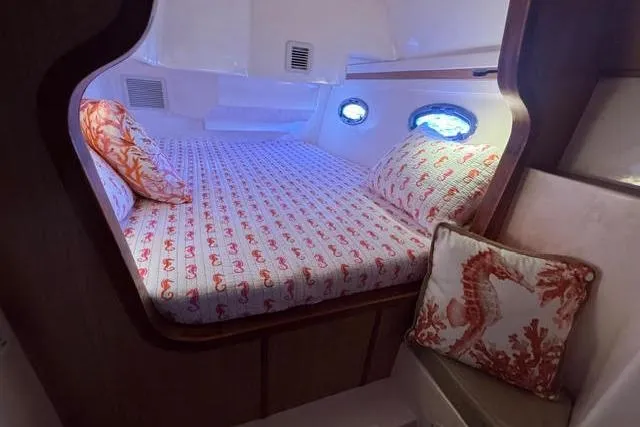 Slide: The Image of Cozy cabin interior of 2007 Africat Marine 420 with nautical-themed bedding and pillows. - 28