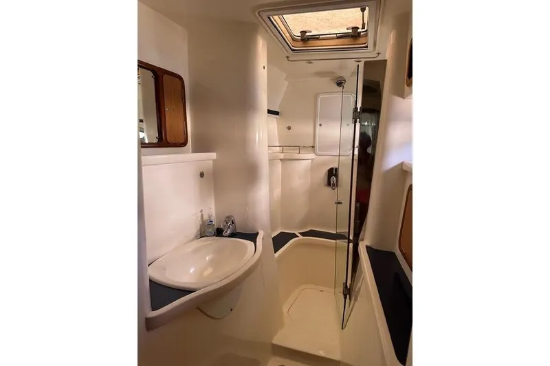 Slide: The Image of 2007 Africat Marine 420 yacht bathroom with sink, mirror, and shower. - 29