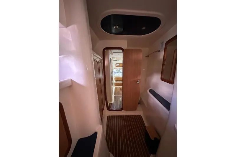 Slide: The Image of Interior view of 2007 Africat Marine 420 yacht, featuring a sleek hallway and wooden accents. - 30