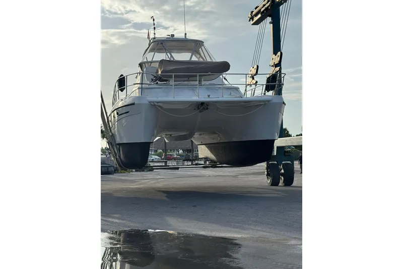 Slide: The Image of 2007 Africat Marine 420 catamaran lifted by crane at a marina. - 34