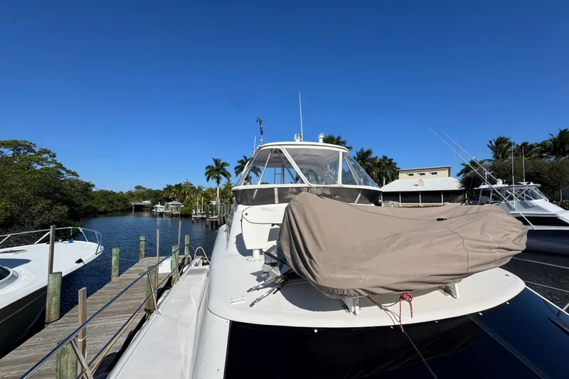 Slide: The Image of 2007 Africat Marine 420 yacht docked in a serene marina under clear blue skies. - 4