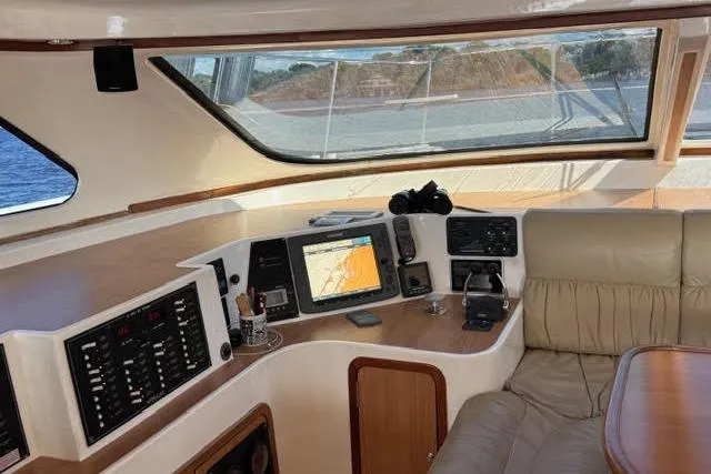 Slide: The Image of Luxurious 2007 Africat Marine 420 yacht interior with navigation equipment and comfortable seating. - 42